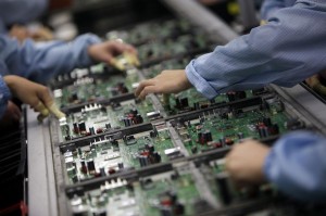 Celestica employees work at a production line in a factory in Dongguan, China's southern Guangdong province