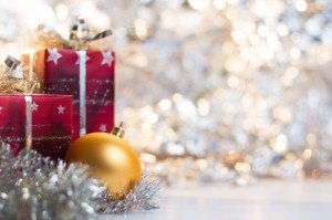 Christmas ball and gifts on abstract light background