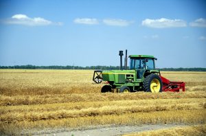 Tractor harvesting grain, North Dakota